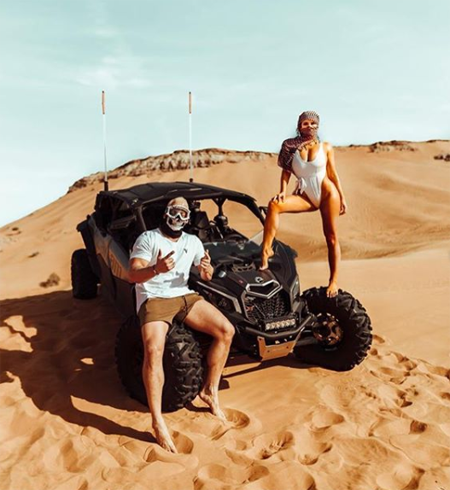 Vitaly and Kinsye on a desert vehicle.